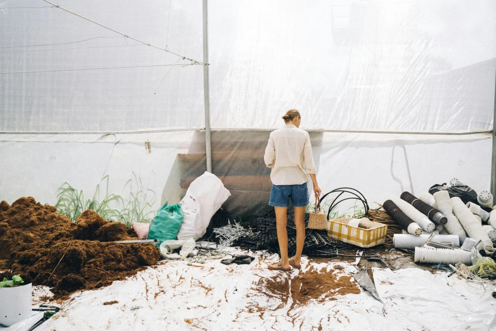 Farm life tips for an organized backyard work area with tools, baskets, and a ready garden workspace