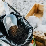 Soil tips for refreshing backyard garden soil between planting cycles with compost and cleared beds