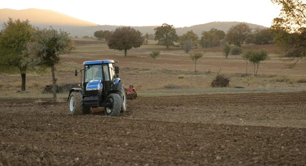 farmer checking soil conditions
